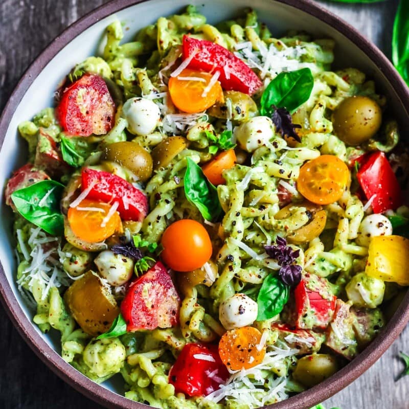 Pesto Pasta Salad w/ cherry tomatoes, baby mozzarella, olives & fresh basil tossed in a Creamy Pesto Dressing. Vegan, gluten-free adaptable.