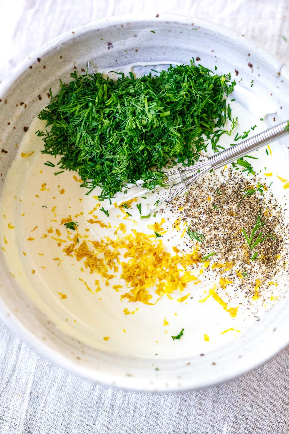 mixing salmon dill sauce in a bowl