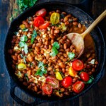 A twist on the classic Frijoles Rancheros- this version is made with pinto beans and homemade enchilada sauce, and crumbled queso fresco cheese, baked in the oven until melty. Vegan-adaptable. 