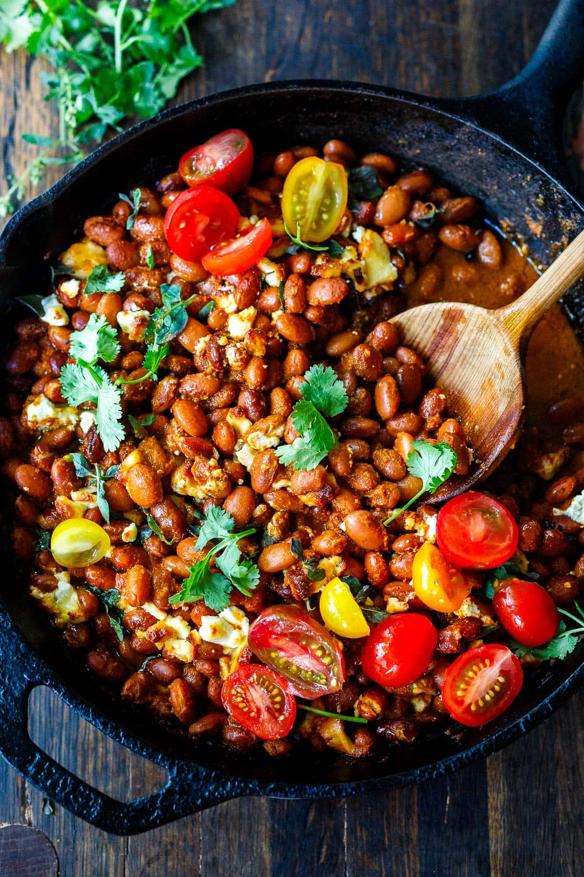 Baked Enchilada Beans with saucy enchilada sauce and Mexican cheese, baked in the oven.