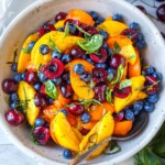 This luscious Fruit Salad is made with summer ripe stone fruit and berries. Cherries, peaches, and apricots along with blueberries and fresh basil- tossed in a delicious vanilla balsamic dressing.