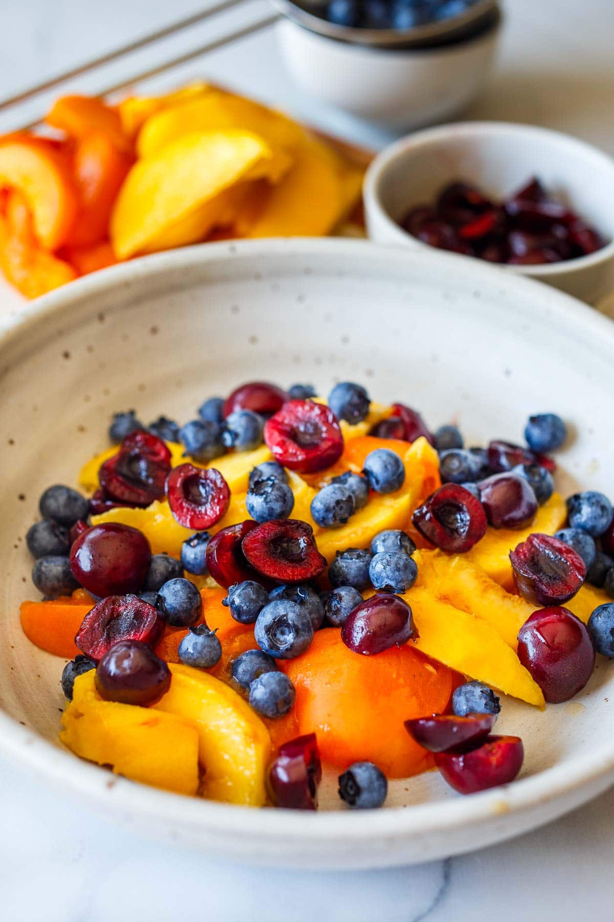 Assembling the fruit salad.