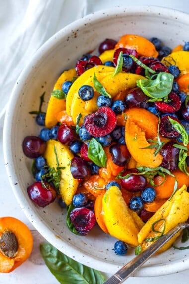 This luscious Fruit Salad is made with summer ripe stone fruit and berries. Cherries, peaches, and apricots along with blueberries and fresh basil- tossed in a delicious vanilla balsamic dressing.