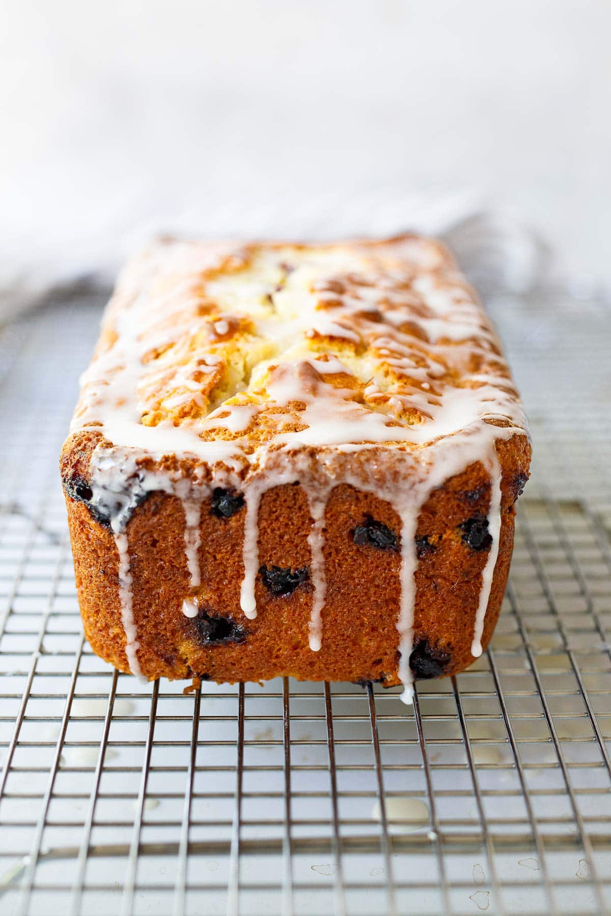 Huckle berry Cake with Lemon glaze over the wire rack. 