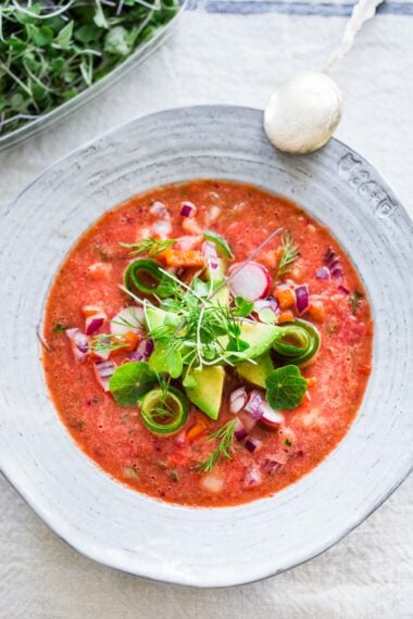 Cool and refreshing, Watermelon Gazpacho is just what the doctor ordered on hot summer days! Topped with cool crunchy cucumber, red onion, red bell pepper, avocado, microgreens, and fresh herbs, it’s a treat for the senses and nourishing to the body!