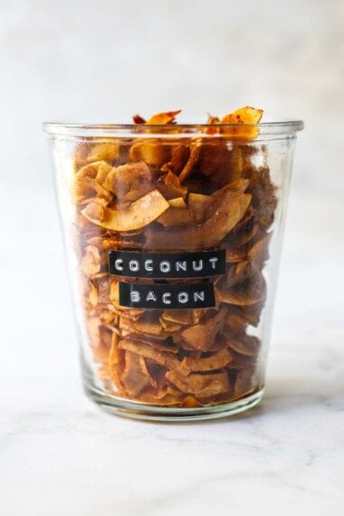 This crispy Coconut Bacon recipe is easy to make in just 15 minutes. A savory, smoky, vegan topping for salads, soups, wraps & avocado toast!