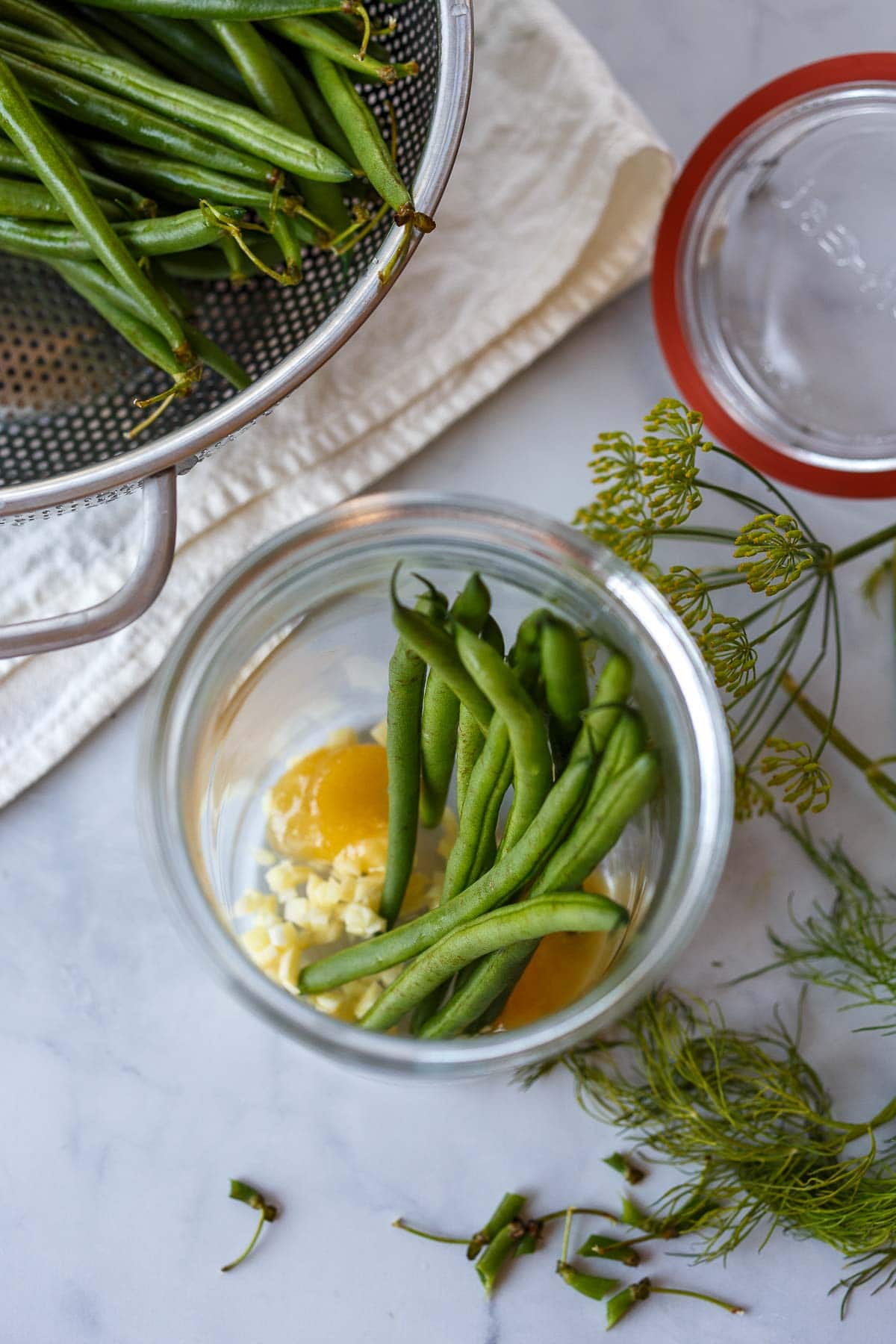 A jar with green beans. In the making of Dilly Beans.