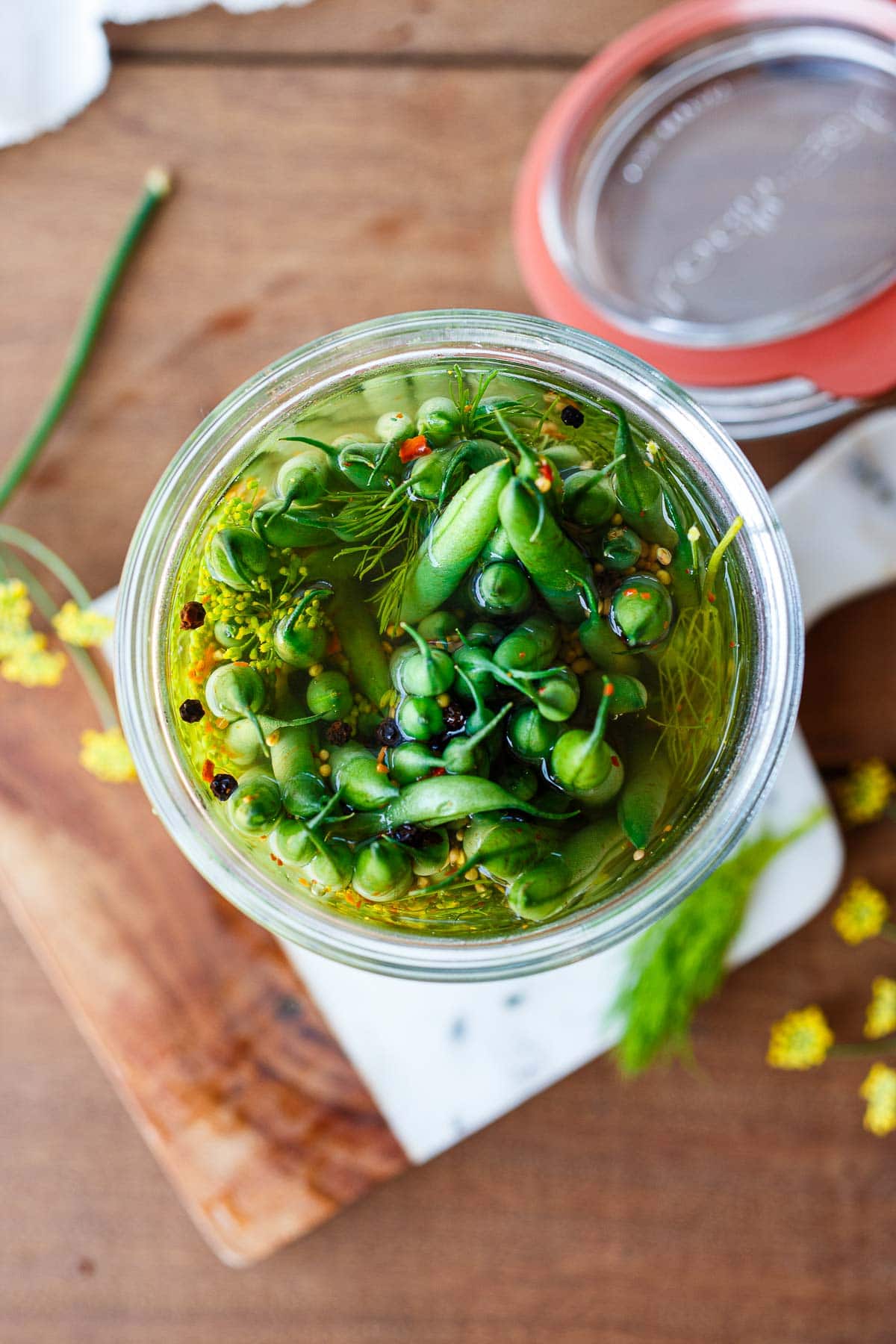 How to make Dilly Beans! This dilly beans recipe is quick and easy to make and full of tangy dill and garlic flavor.  Crisp and fresh pickled green beans are a tasty way to preserve them and make for a beautiful gift. 