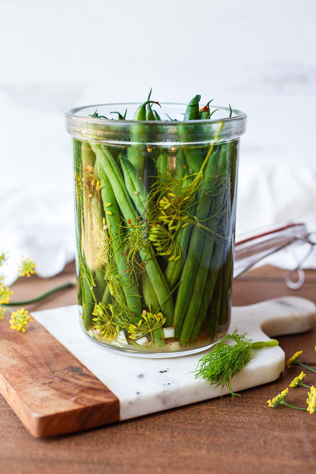 How to make Dilly Beans- a quick and easy recipe for pickled green beans that can be used in Bloody Marys, on charcuterie boards and cheese boards, or serve as a tasty snack. 