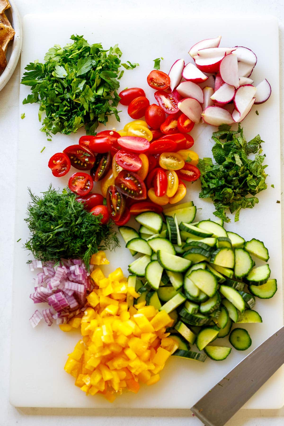 Vegetables and herbs being chopped.