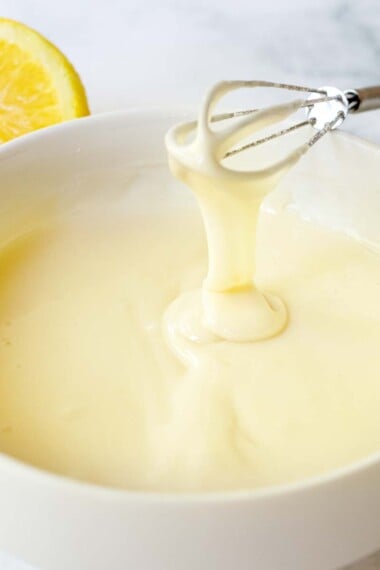 This easy Lemon Glaze is made with three simple ingredients in under 3 minutes flat! It hardens, stays white, and holds its shape, perfect for cakes, scones, cookies and morning breads. Vegan & gluten-free.