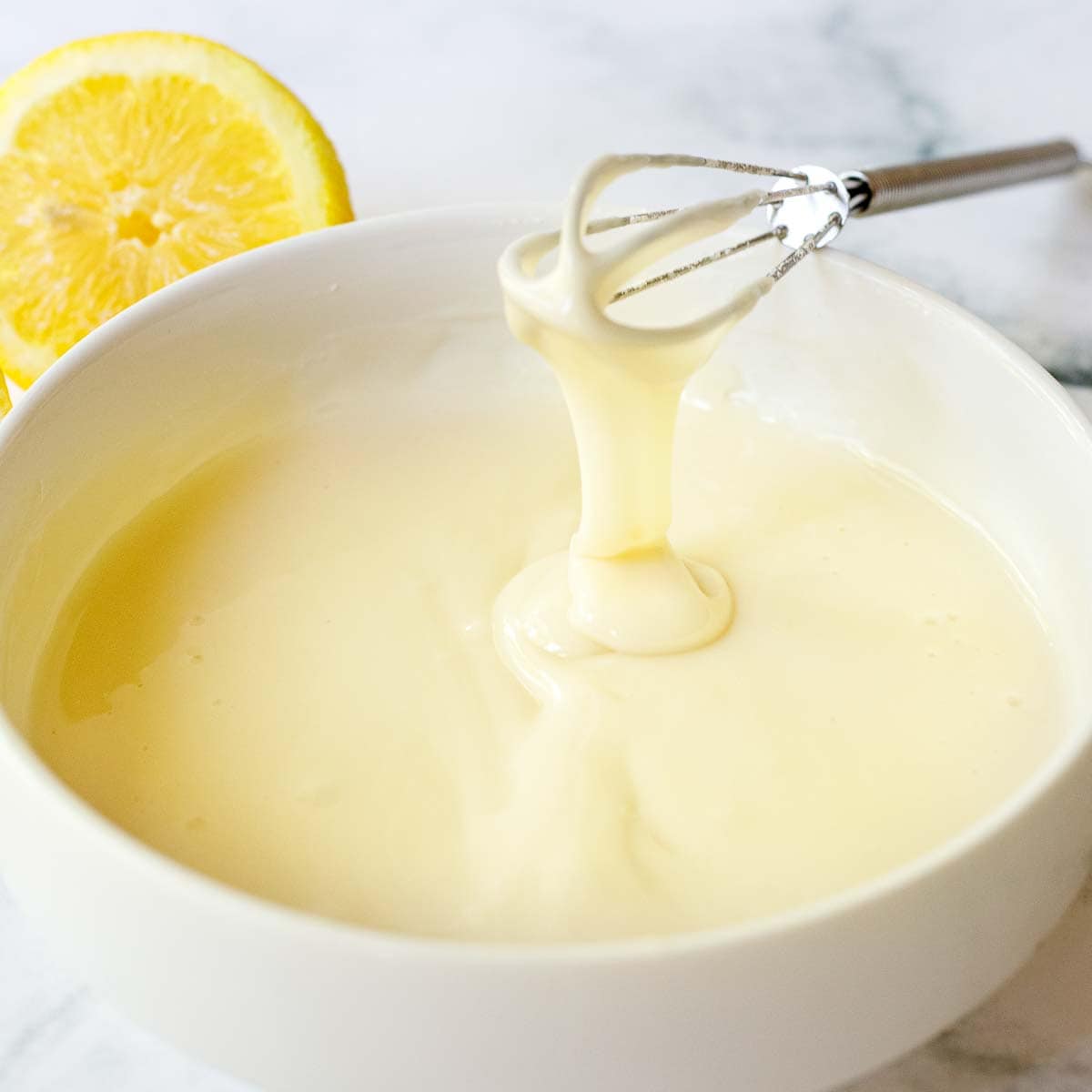 This easy Lemon Glaze is made with three simple ingredients in under 3 minutes flat! It hardens, stays white, and holds its shape, perfect for cakes, scones, cookies and morning breads. Vegan & gluten-free.