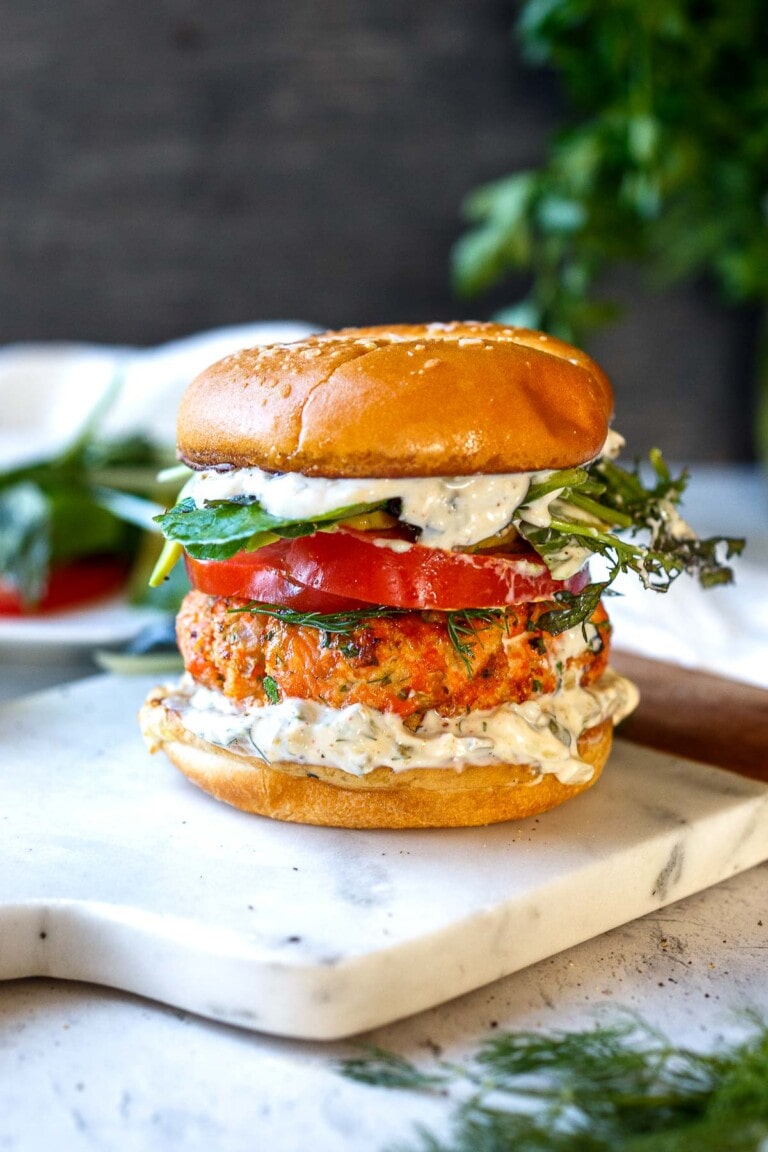Grilled Salmon Burgers made with fresh salmon and topped with homemade dilly tartar sauce. A perfect summer meal bursting with delicious flavor and healthy omega-3s!