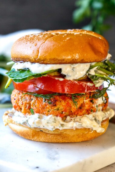 Healthy delicious Salmon Burgers are easy to make with fresh salmon! Grillable and flavorful with the best texture. A perfect summer meal bursting with delicious flavor and healthy omega-3s!
