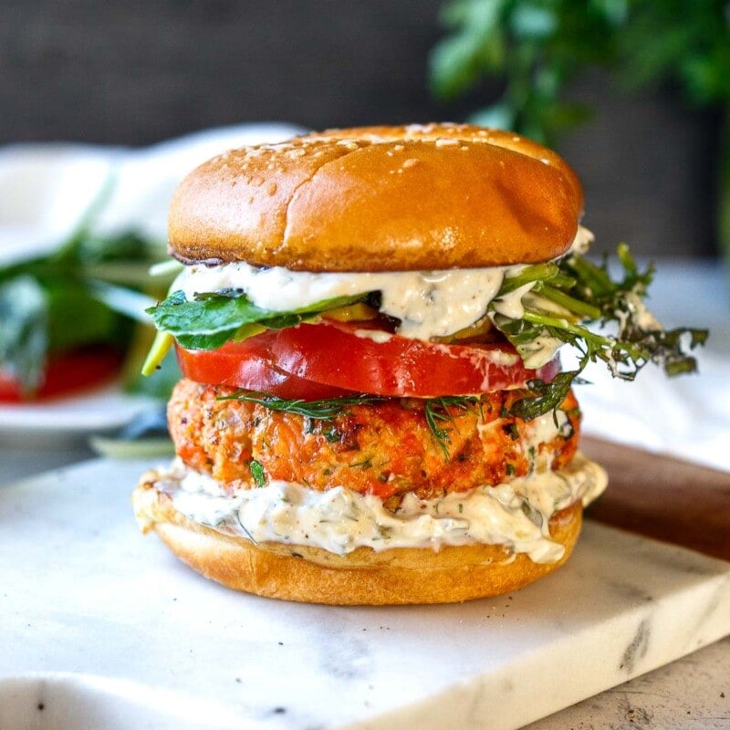Healthy delicious Salmon Burgers are easy to make with fresh salmon! Grillable and flavorful with the best texture. A perfect summer meal bursting with delicious flavor and healthy omega-3s!