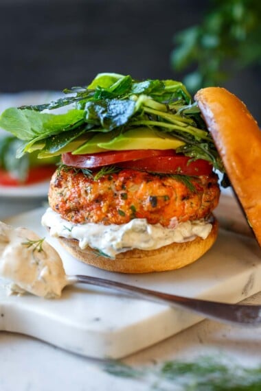 Healthy delicious Salmon Burgers are easy to make with fresh salmon! Grillable and flavorful with the best texture. A perfect summer meal bursting with delicious flavor and healthy omega-3s!