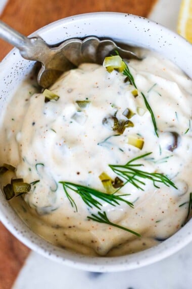 Homemade Tartar Sauce is easy to make with a few simple, fresh ingredients- we add capers, fresh dill and crunchy dill pickles for the best flavor. A creamy, tangy condiment, perfect for salmon, fish or seafood!