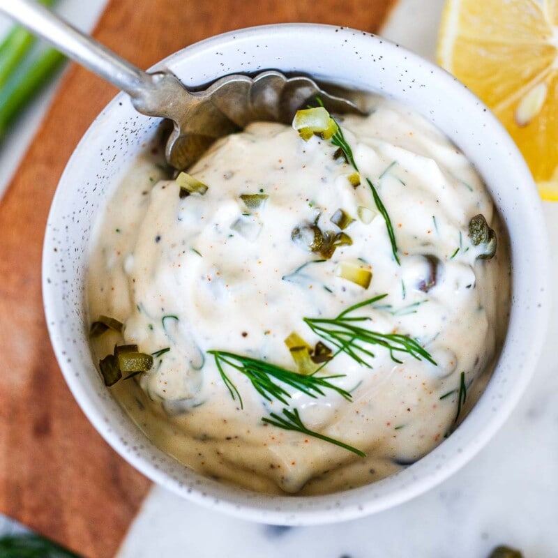 Homemade Tartar Sauce is easy to make with a few simple, fresh ingredients- we add capers, fresh dill and crunchy dill pickles for the best flavor. A creamy, tangy condiment, perfect for salmon, fish or seafood!