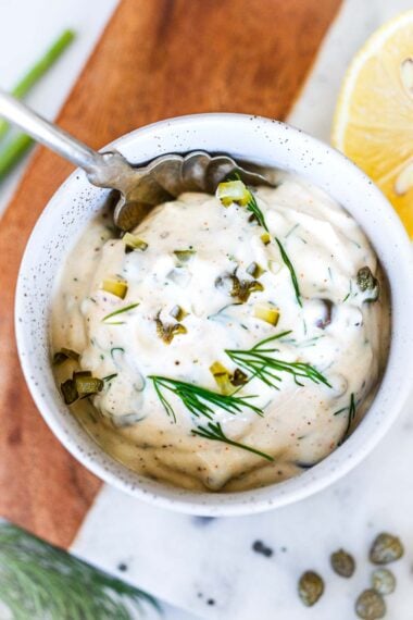 Homemade Tartar Sauce is easy to make with a few simple, fresh ingredients- we add capers, fresh dill and crunchy dill pickles for the best flavor. A creamy, tangy condiment, perfect for salmon, fish or seafood!