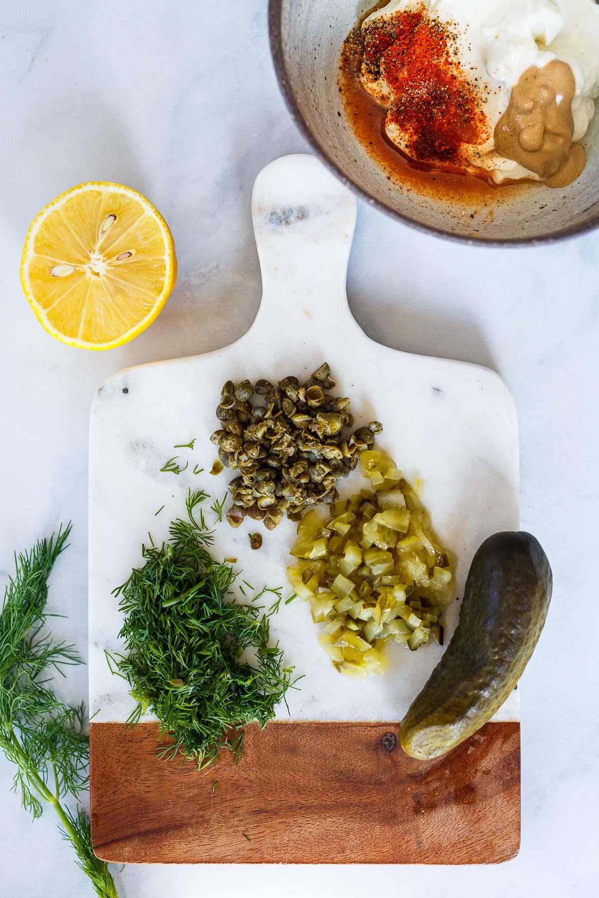 chopping the tartar sauce ingredients. 