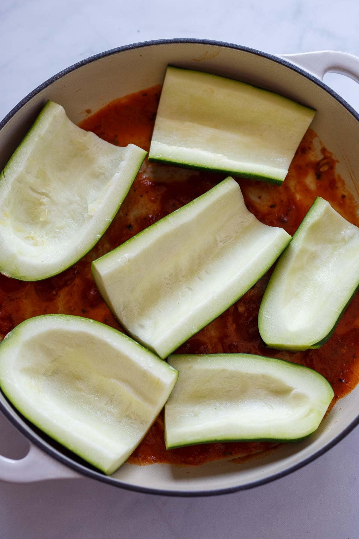 Zucchini shells in a pan for Stuffed Zucchini.