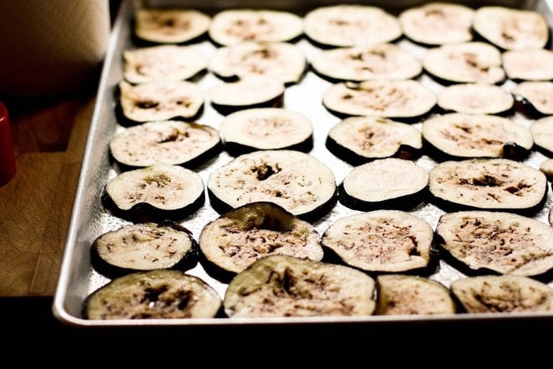 sliced eggplant on baking sheet.