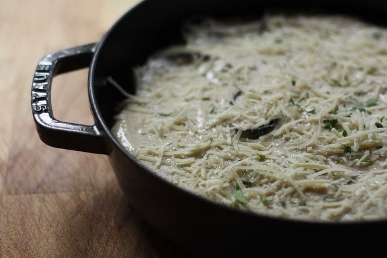 grated cheese on top of béchamel layer to make moussaka.