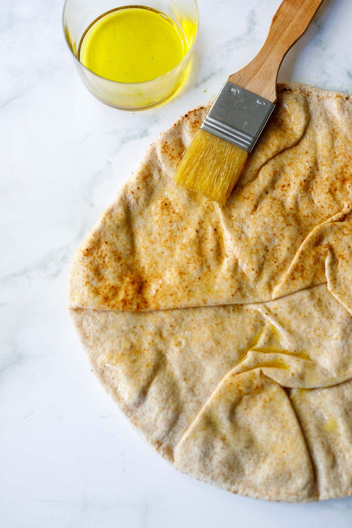 pita bread round with olive oil brushed on top