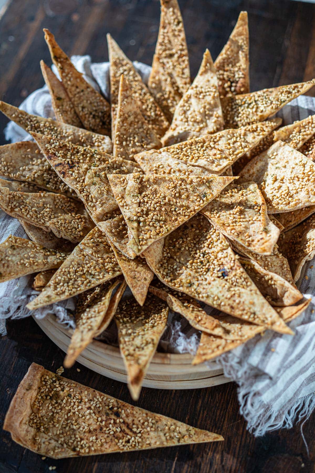 bucket of homemade pita chips with sesame seeds