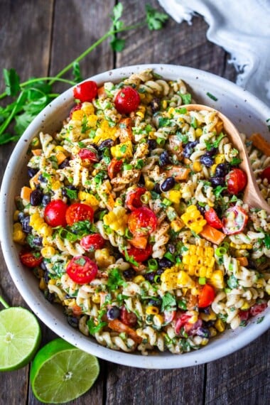 Southwest Pasta Salad is so satisfying with just the right amount of zesty kick. Tender pasta, crunchy fresh veggies, corn, and black beans dressed with a delicious Chipotle Ranch Dressing. The perfect side dish for potlucks, cookouts, and BBQS.