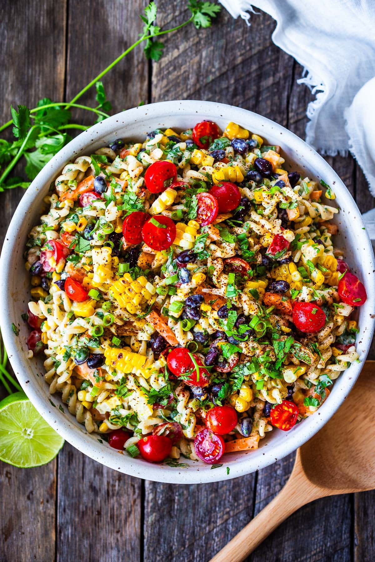 Southwest Pasta Salad is so satisfying with just the right amount of zesty kick. Tender pasta, crunchy fresh veggies, corn, and black beans dressed with a delicious Chipotle Ranch Dressing. The perfect side dish for potlucks, cookouts, and BBQS.