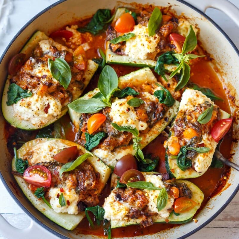 Tender zucchini is stuffed with a savory vegetarian filling of bell pepper, olives and spinach, topped with ricotta & baked in a marinara sauce.