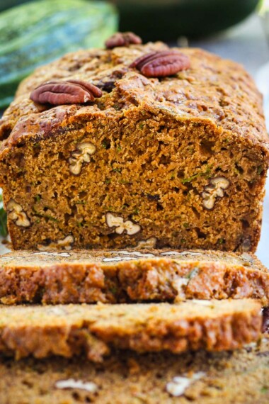 This healthy wholesome zucchini bread is tender and full of flavor.  Made with whole wheat pastry flour and coconut sugar with a touch of orange and rosemary, packing a whole pound of zucchini in one loaf!