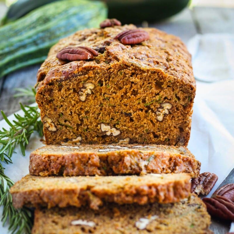 This healthy wholesome zucchini bread is tender and full of flavor.  Made with whole wheat pastry flour and coconut sugar with a touch of orange and rosemary, packing a whole pound of zucchini in one loaf!