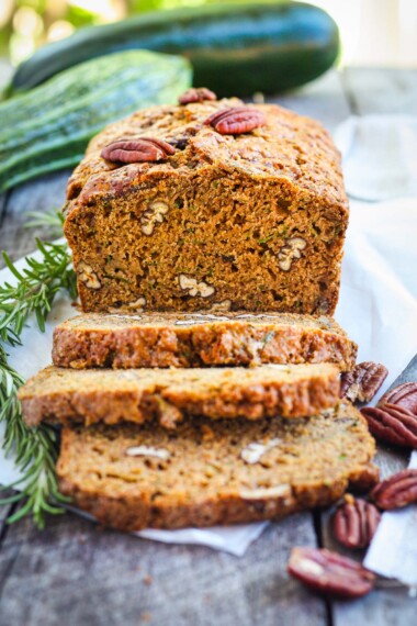 This healthy wholesome zucchini bread is tender and full of flavor.  Made with whole wheat pastry flour and coconut sugar with a touch of orange and rosemary, packing a whole pound of zucchini in one loaf!