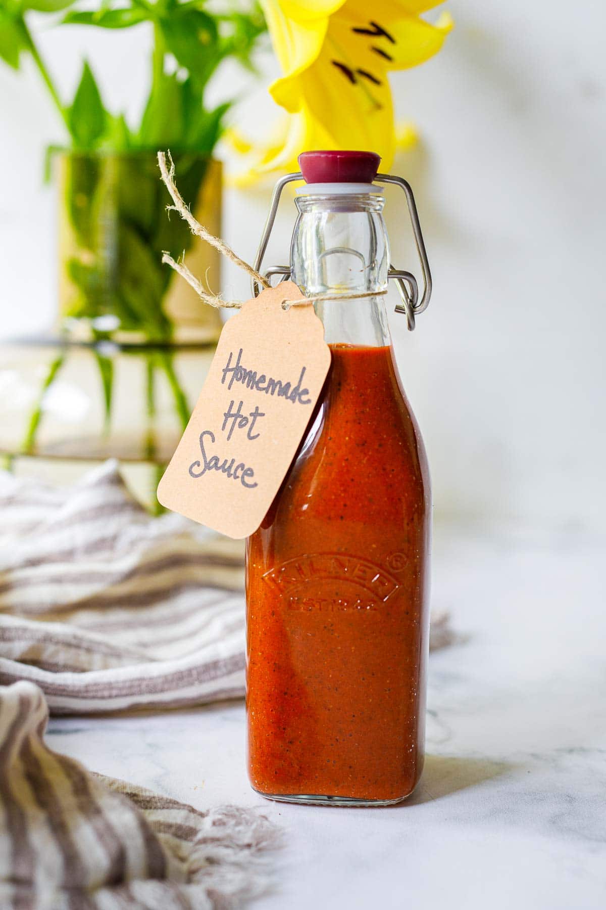 Homemade Hot sauce recipe made with simple ingredients in a bottle with a tag. 