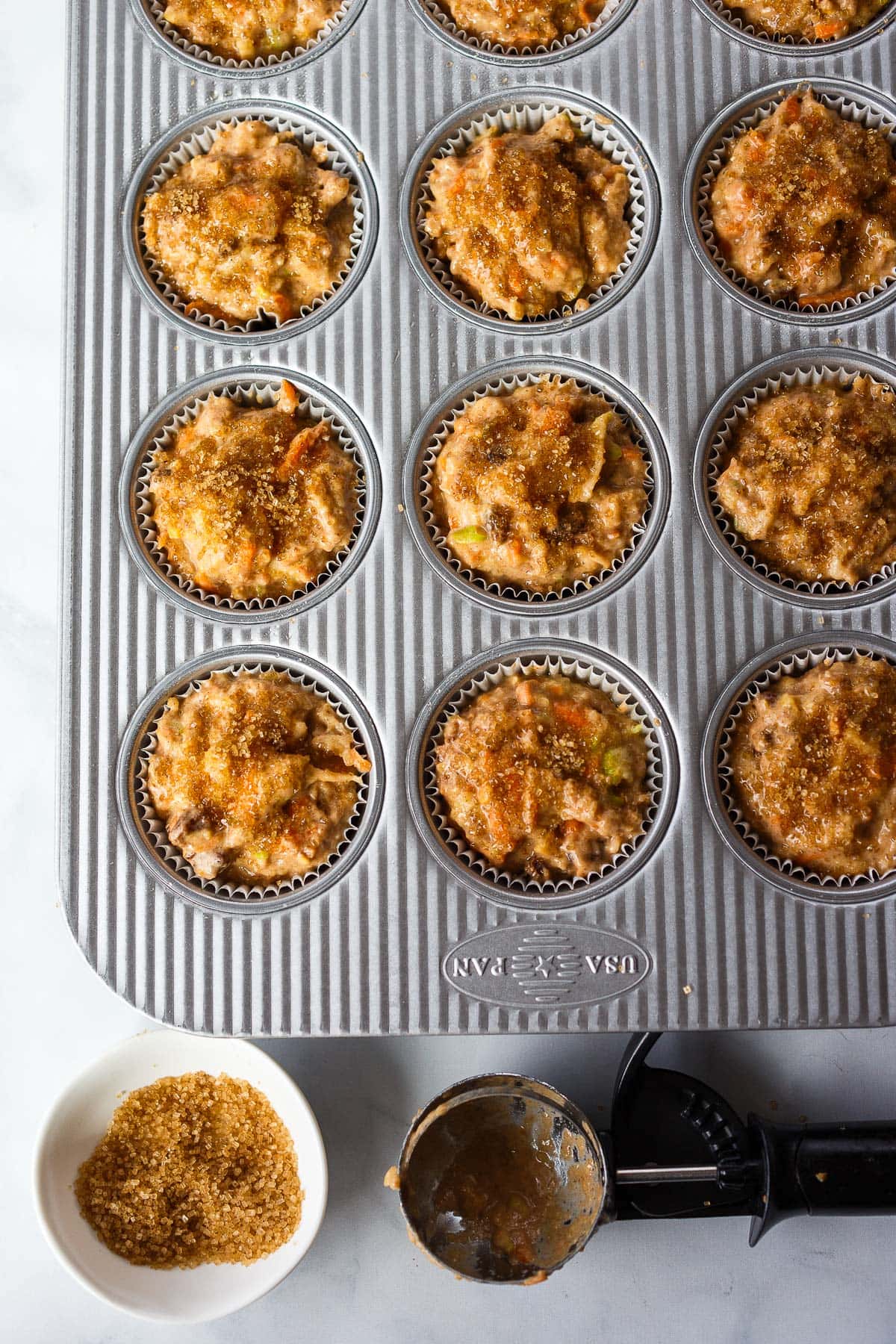 Morning Glory Muffins ready to bake in a muffin tin.