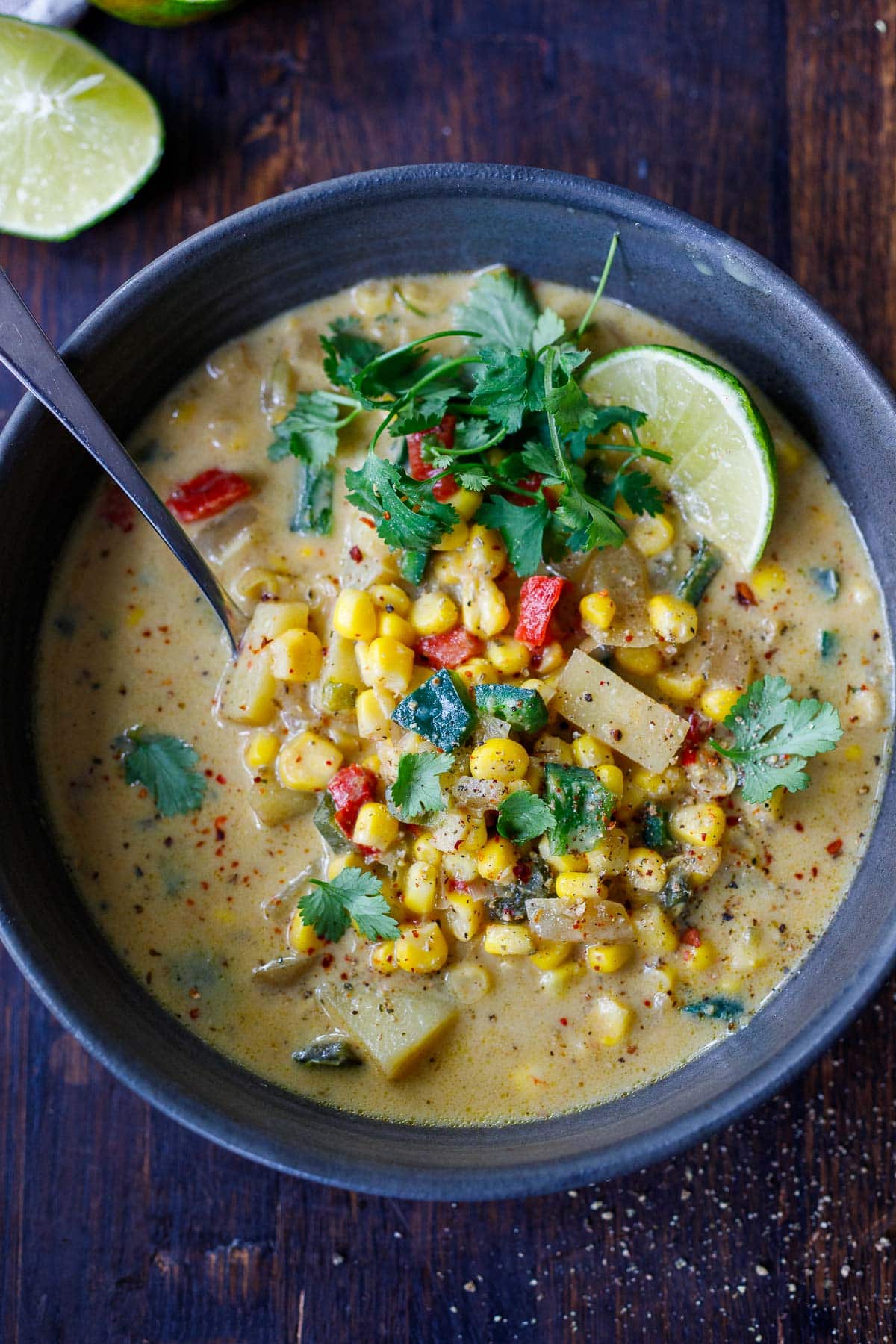 Bowl of poblano corn chowder with lime and cilantro.