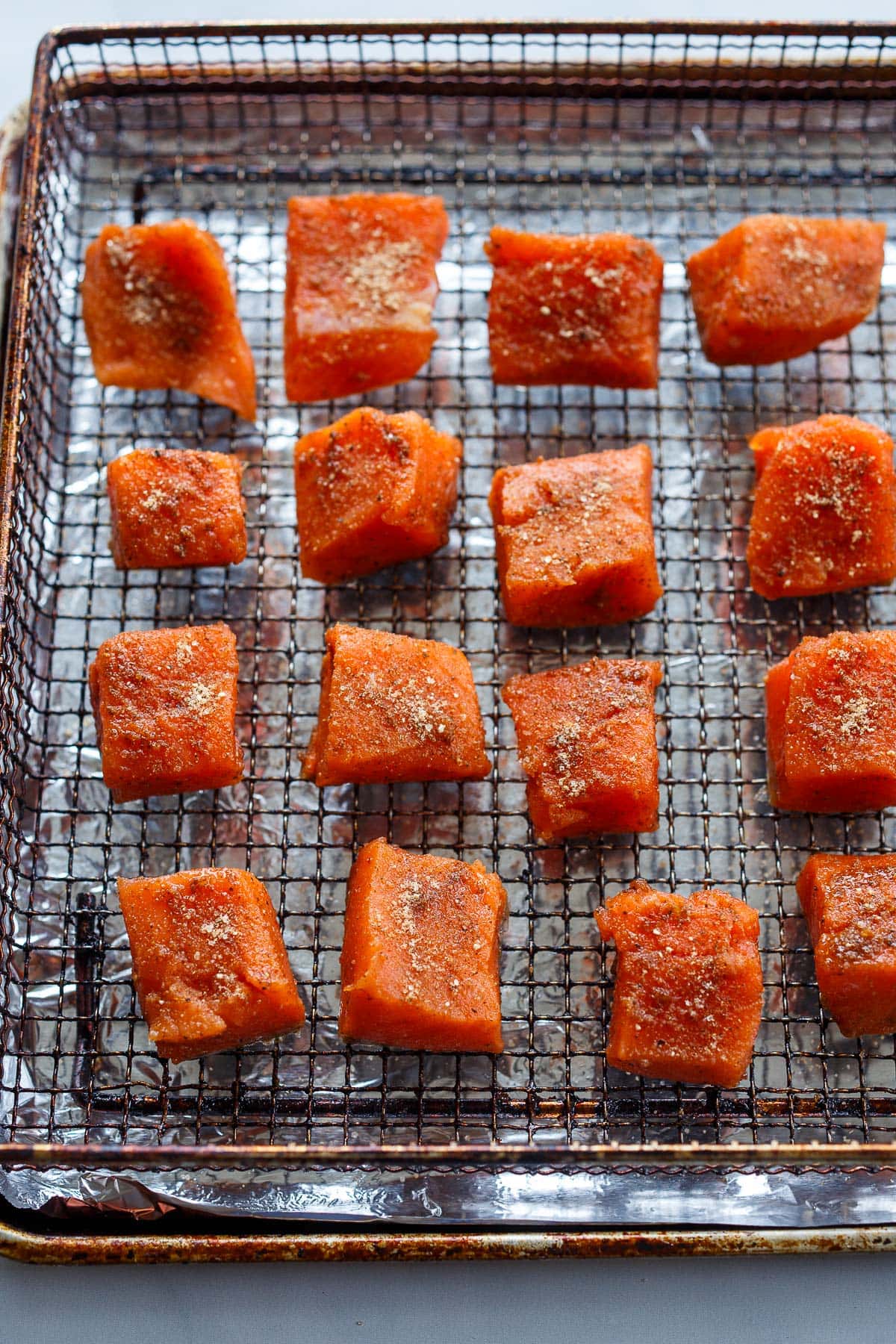 Salmon bites on an airfryer tray.