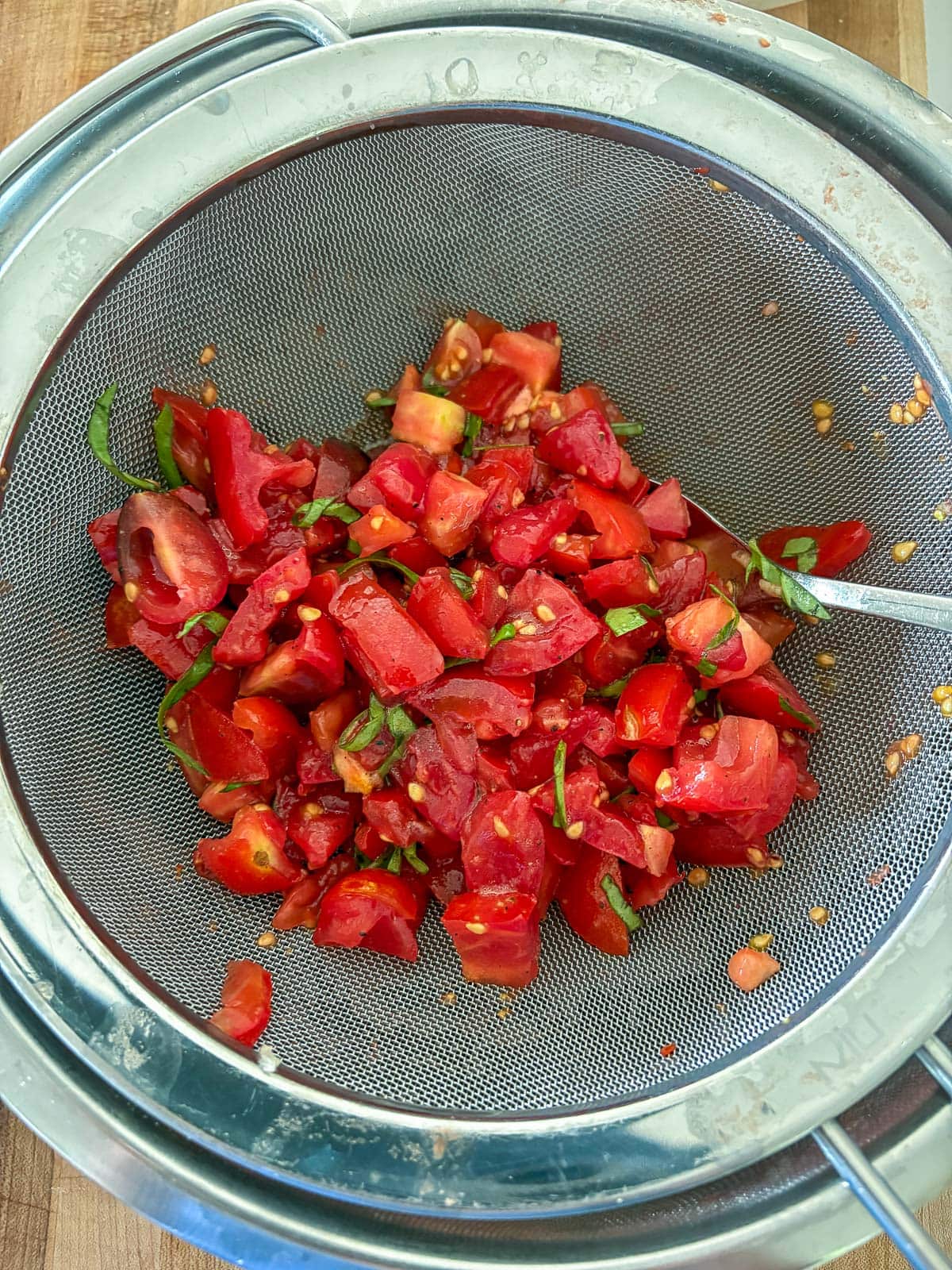 straining the tomatoes