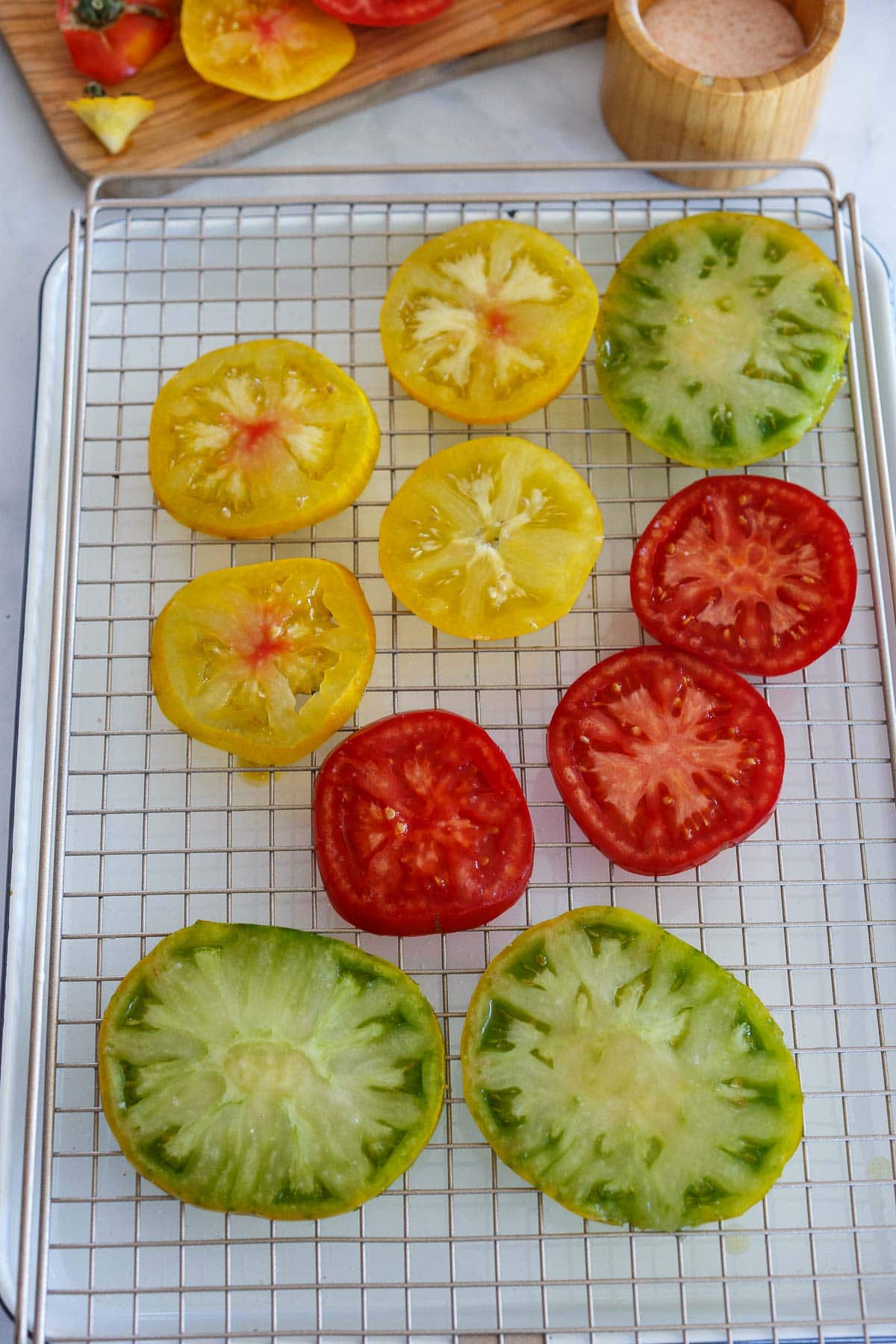 Sliced tomatoes on a wire rack for Tomato Tart.