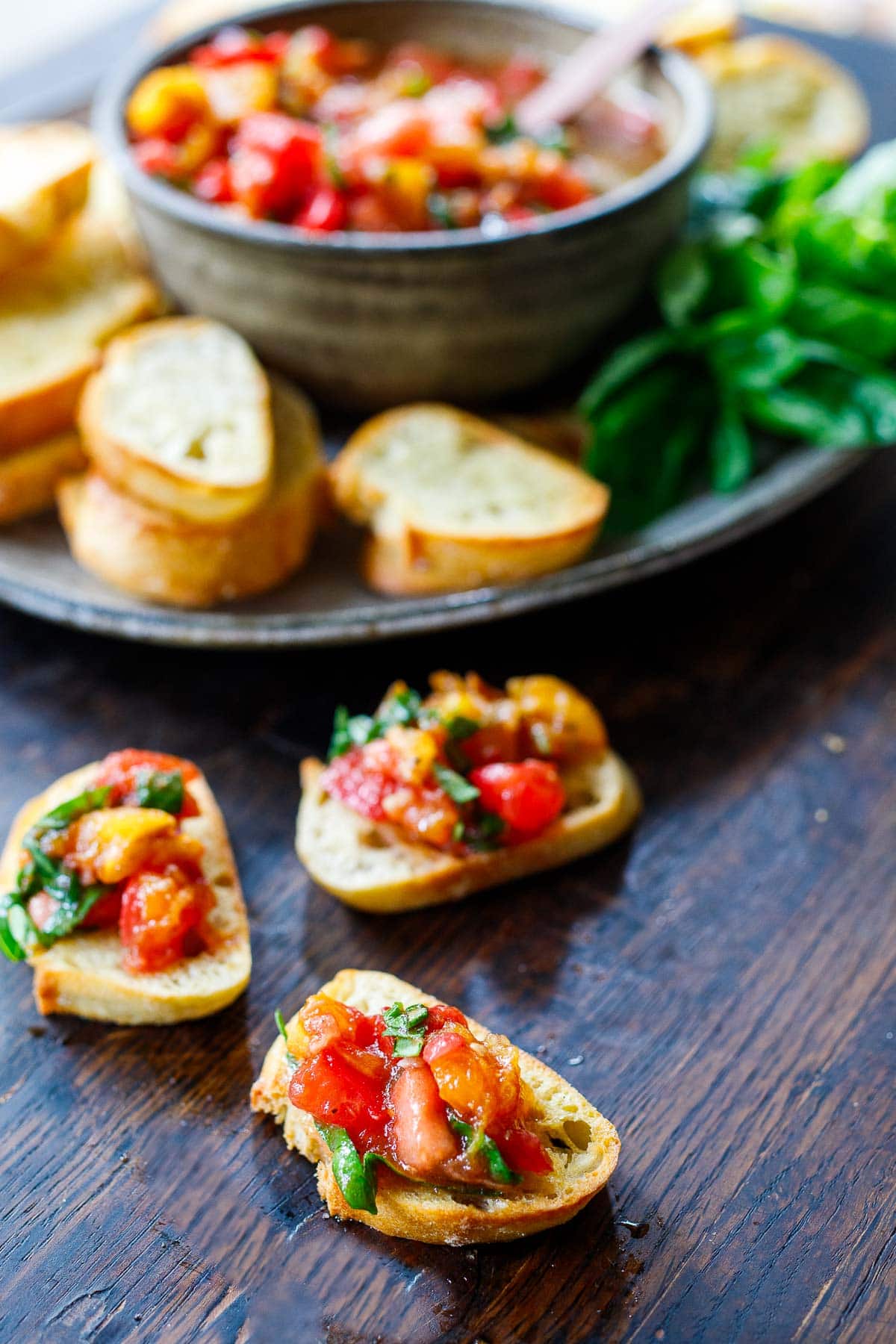 Baguette slices with Tomato Bruschetta spooned over top.