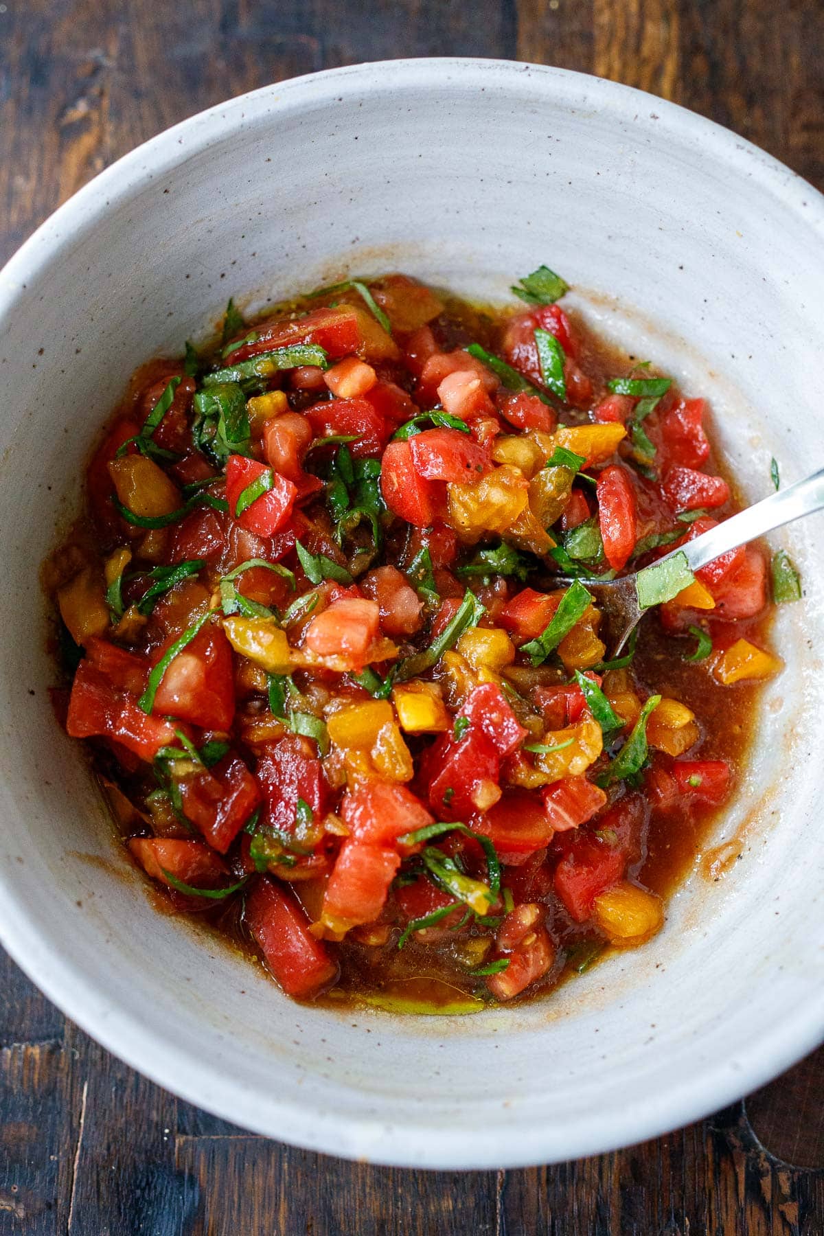 Tomato basil bruschetta mixture combined in bowl