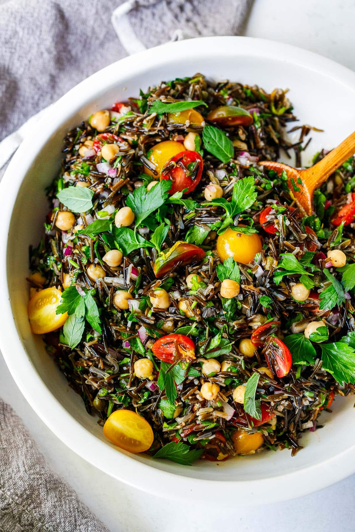 Wild rice salad with cherry tomatoes, chickpeas, and fresh herbs.