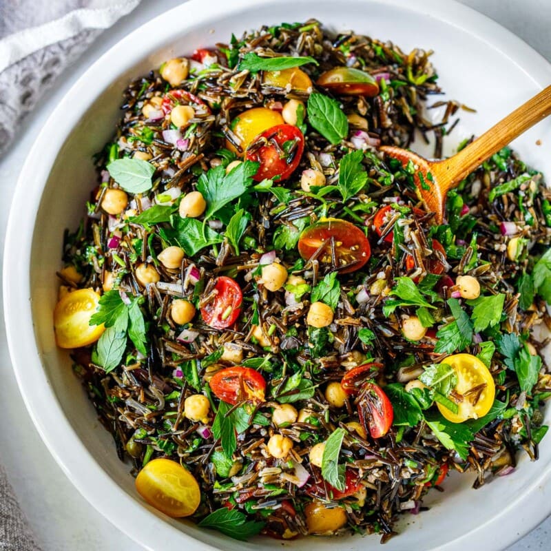 This delicious Wild Rice Salad is the perfect combination of textures and flavors. Made with chickpeas (or chicken breast), cherry tomatoes, red onion, parsley, mint, in a simple lemony dressing. Vegan!