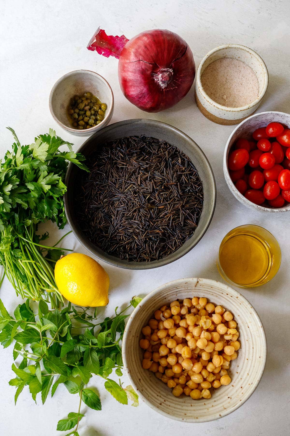 wild rice salad ingredients in bowls.