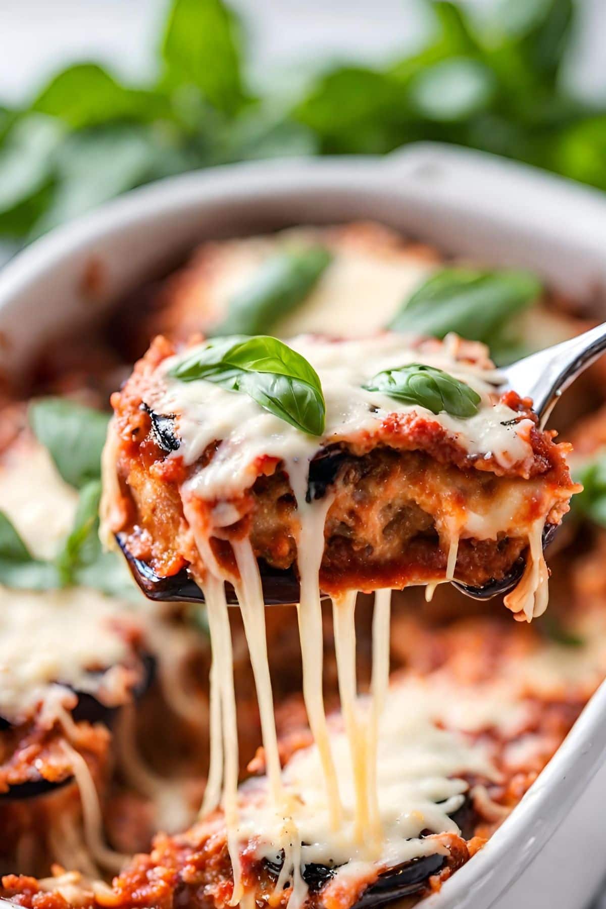 eggplant parmesan being liftedout of a baking dish.