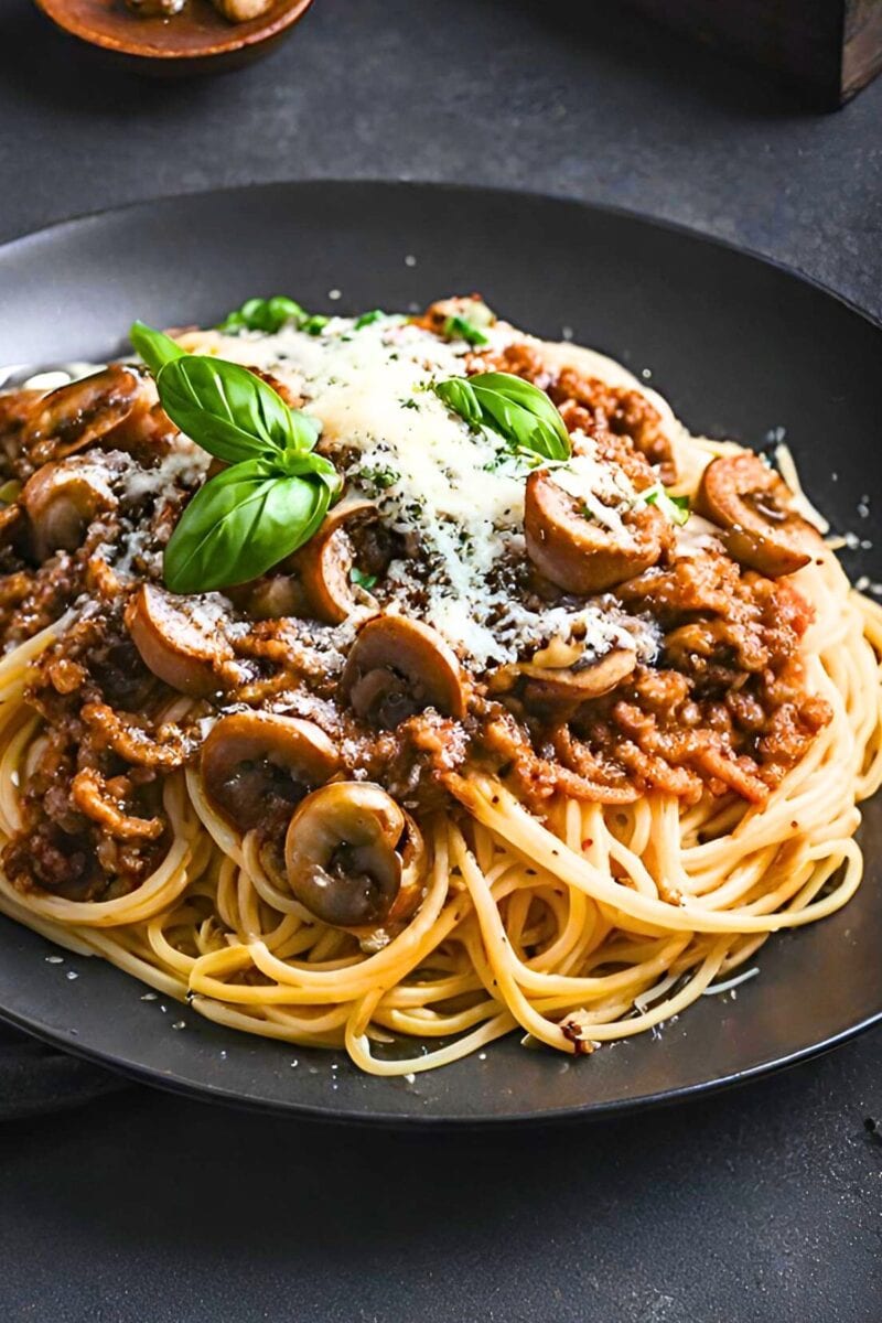 This Bolognese Sauce (aka Sunday Sauce) is hearty, robust and full of depth and flavor! Make it in a slow cooker, on the stovetop or in an Instant pot. We lighten it up with ground turkey (optional) and add mushrooms for extra umami. 