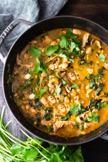 This delicious White Bean Chicken Chili is made with tender shredded chicken, white beans, poblano chilies, cilantro, coriander and lime- a tasty one-pot meal the whole family will love! www.feastingathome.com