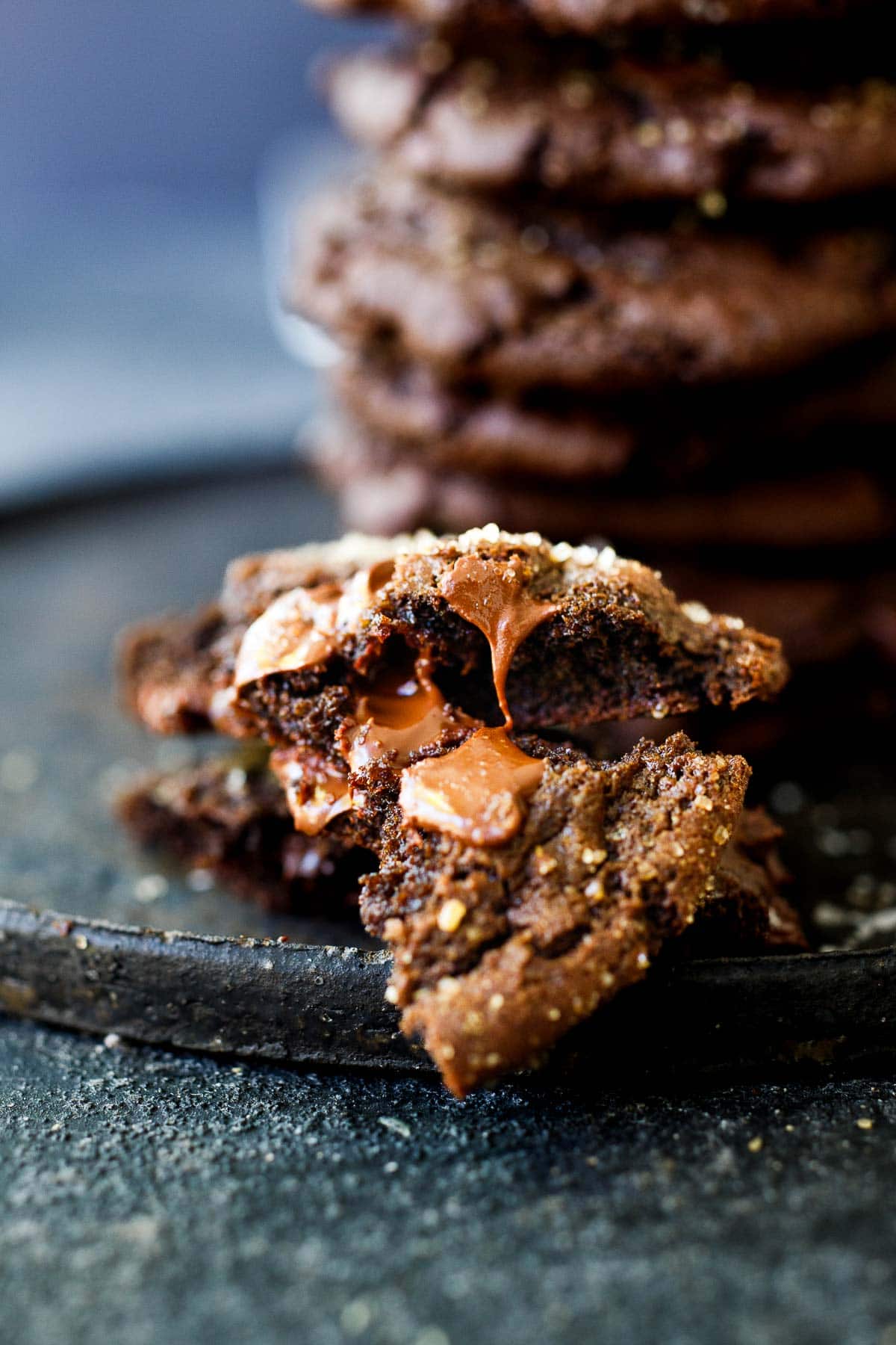 double chocolate chip cookie broken in half with melted chocolate chunk